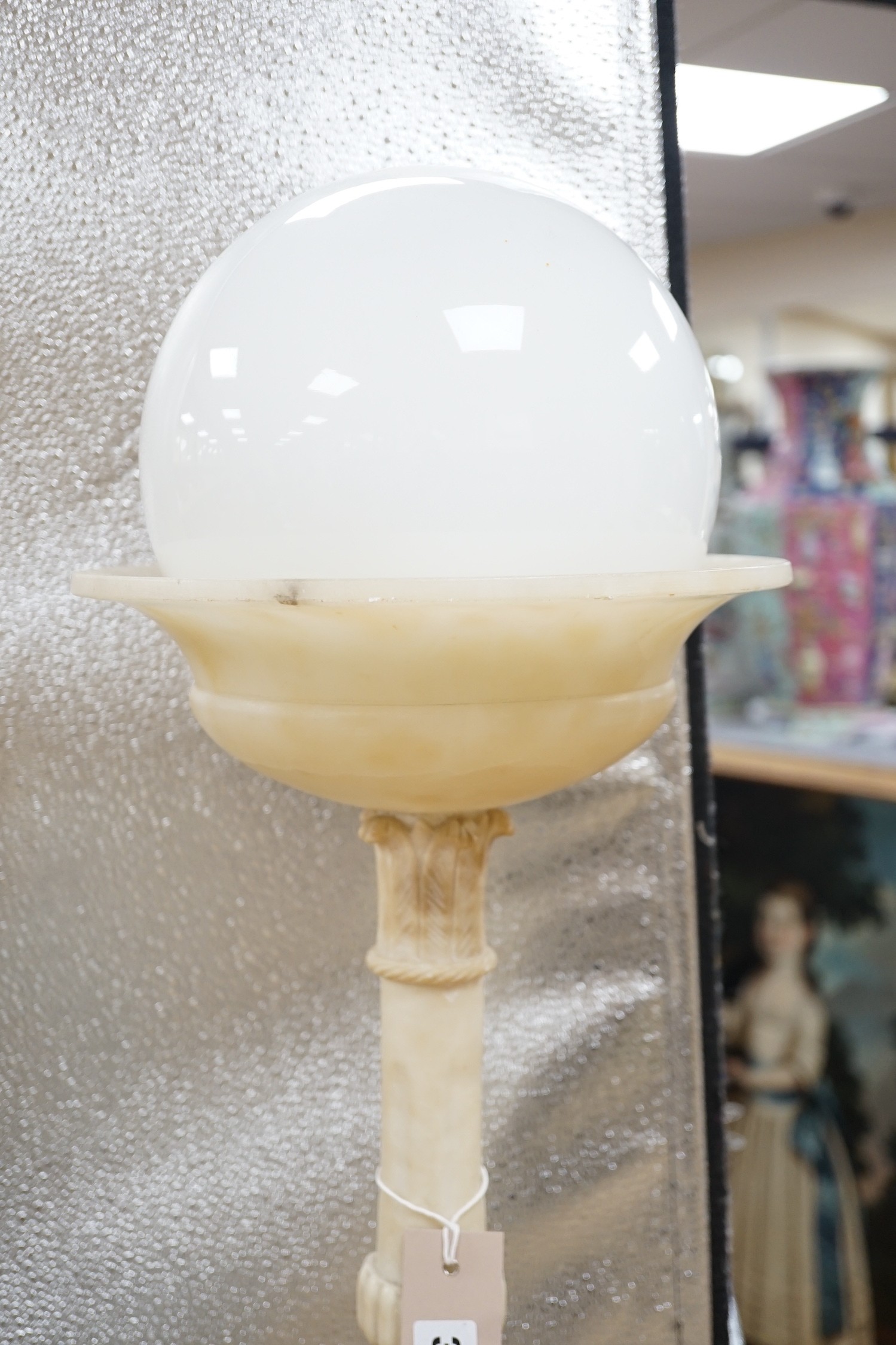 A 1920's carved alabaster clown group figure lamp. 85cm tall
